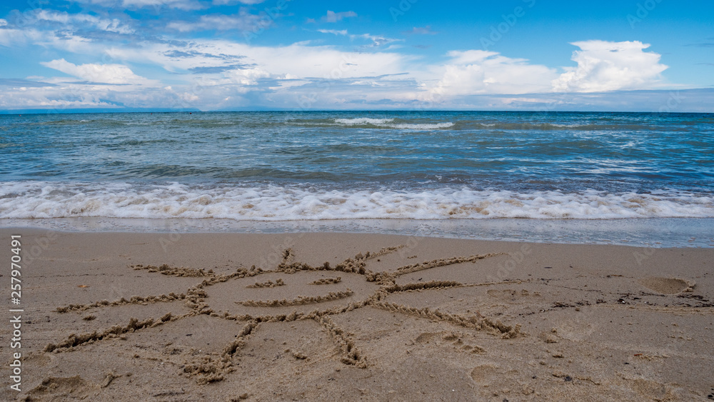 Sun smiling on the beach with a beautiful sea Sun smiling on the beach with a beautiful sea