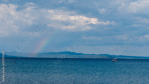 Rainbow over the sea and blue sky © Sforaru