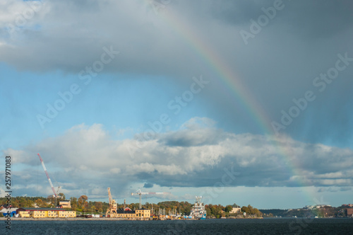 Rainbow over autumn city. Stockholm on a autumn sunny day. City port