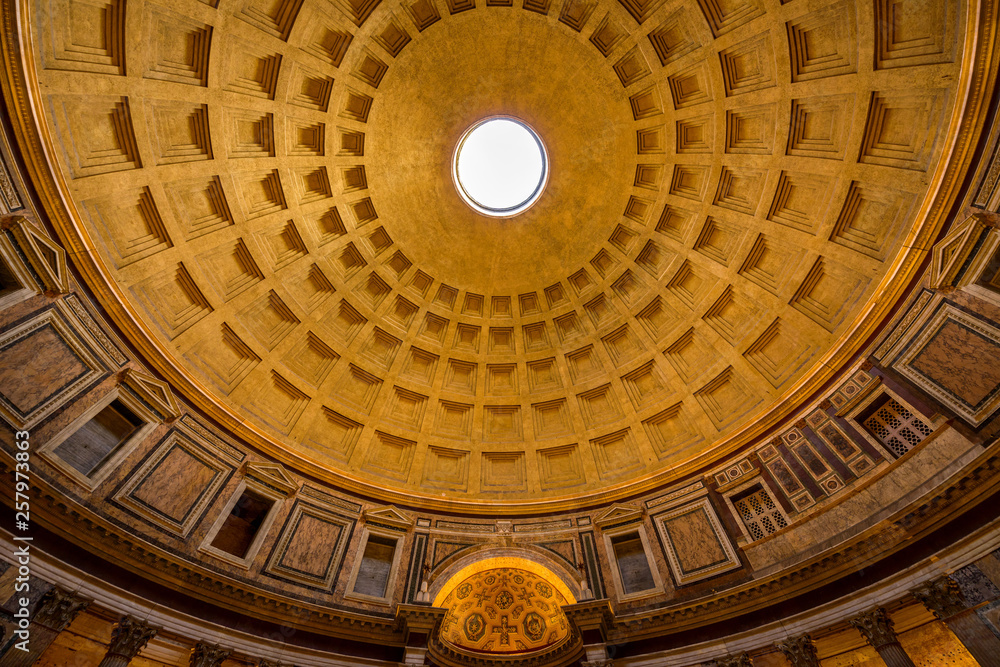 Pantheon Dome - A wide-angle view of 1st-century coffered concrete dome, lighted up at evening, of the Pantheon, a church converted from an ancient Roman temple. It's now a state property. Rome, Italy