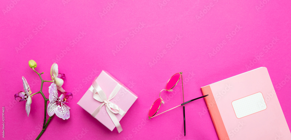 Women. Flowers and female accessories against pink background, copy space