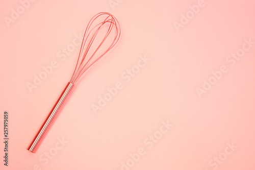 whisk on  pink pastel background. Top view, minimalism. toned Living coral © Masarik