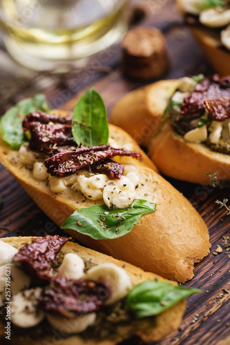 sandwich with mozzarella cheese, pesto, sun-dried tomatoes and basil and thyme