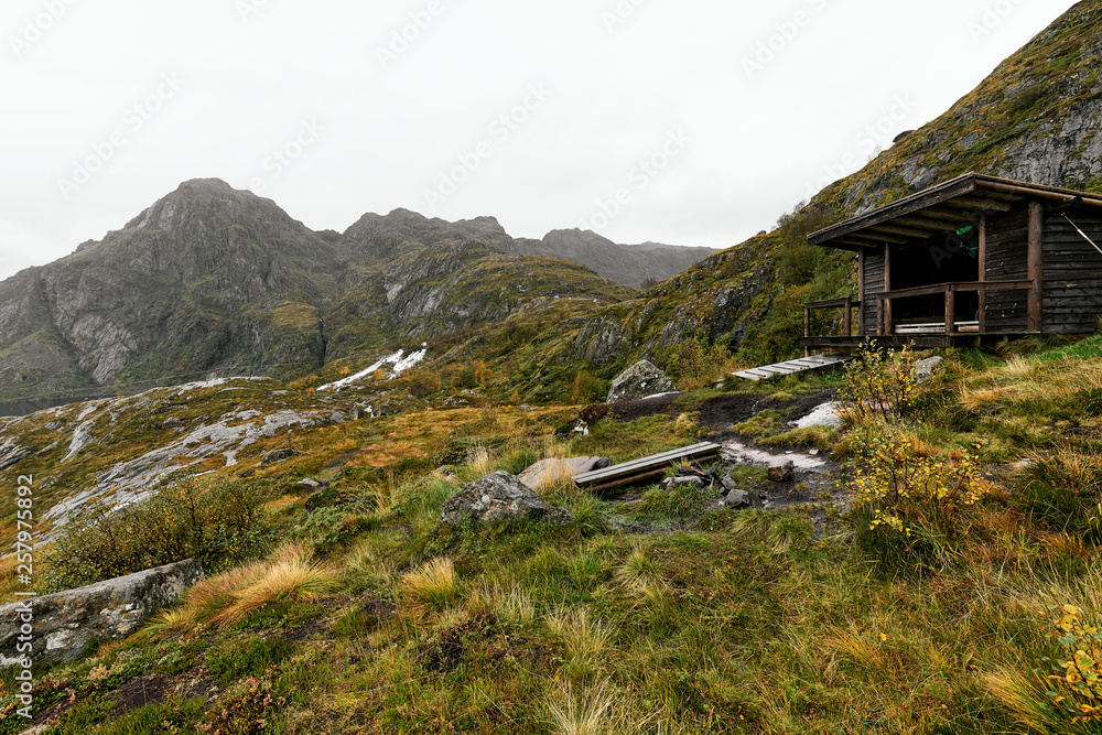 Wooden cabin in the mountains on Lofoten Islands in Norway at the coast Wooden cabin in the mountains on Lofoten Islands in Norway at the coast