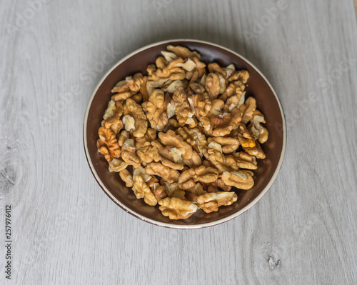 Healthy food  for background image close up walnuts.  Nuts  texture on white grey table top view on the cup plate