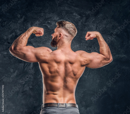 Shirtless bearded man showi...