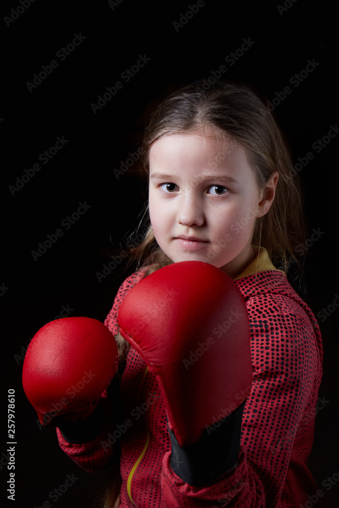 The girl with red overlays on her hands on a black background The girl with red overlays on her hands on a black background