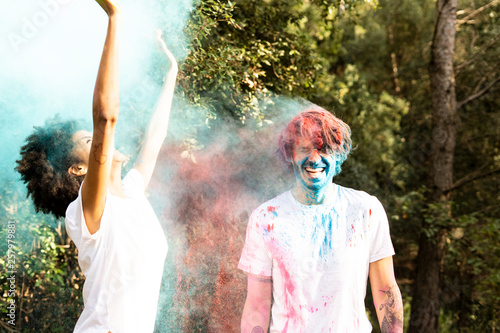 Couple throwing colorful powder paint, celebrating Holi, Festival of Colors photo