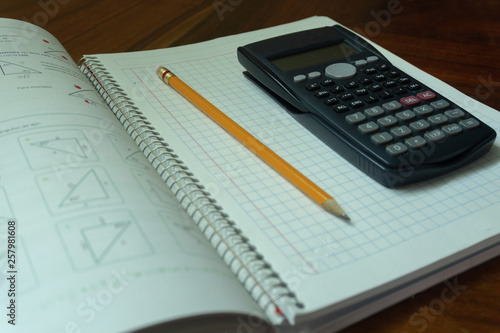 Calculator, notebook and pen.