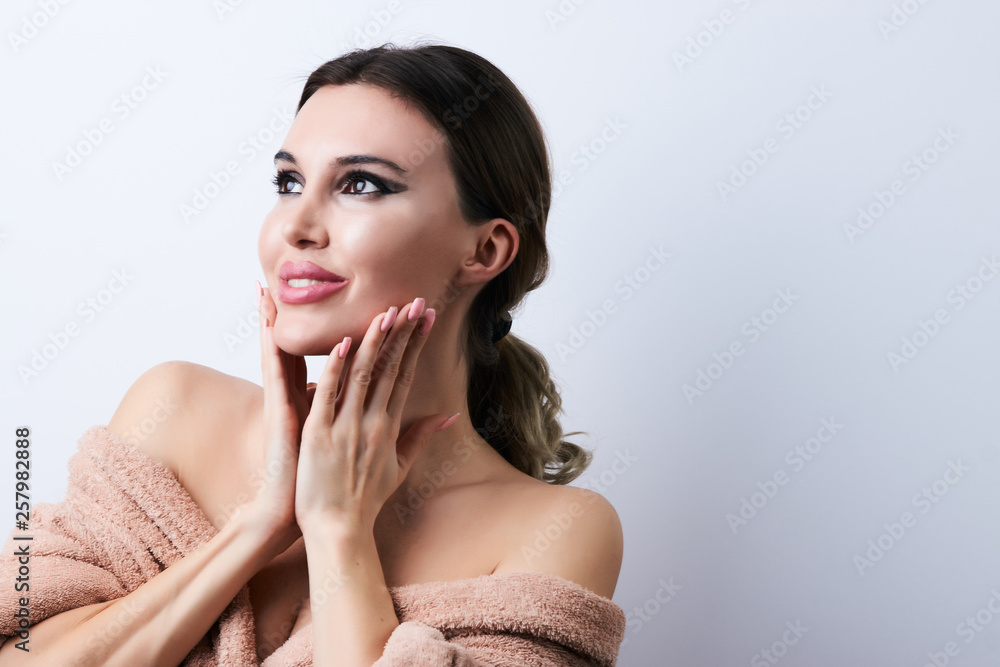 Happy beautiful young woman with clean fresh skin touch her face, close-up. Happy beautiful young woman with clean fresh skin touch her face, close-up.