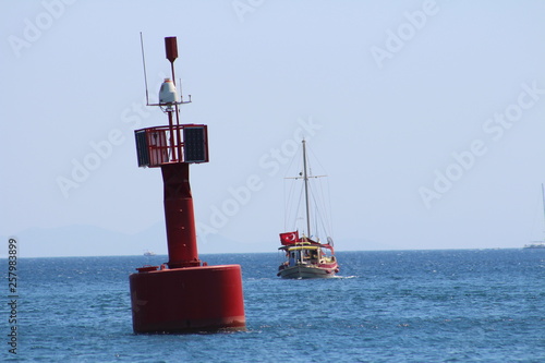 Red lighthouse and yatch