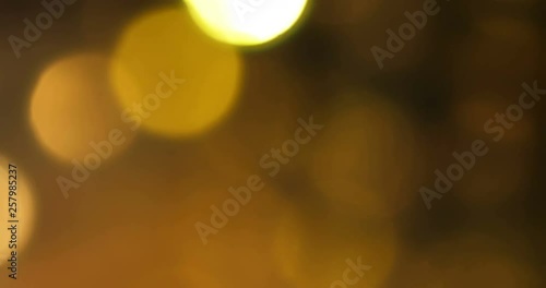 Gold Lens Flares and Refractions.  Gold shimmering bokeh against a rich dark background. Real light, not CGI. Composite over footage or use as background. Luxury feel  for commercials.
