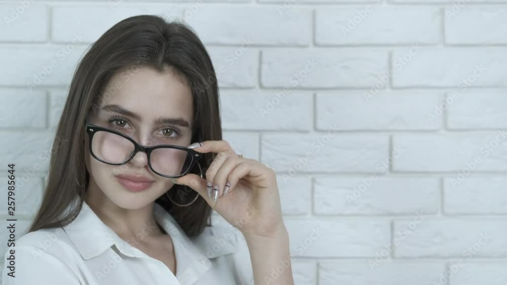 Portrait of a girl with glasses. Charming girl with glasses for sight. Portrait of a girl with glasses. Charming girl with glasses for sight.