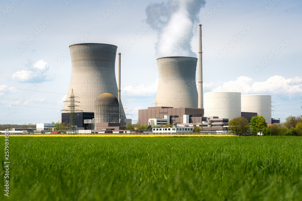 Nuclear power plant with yellow field and big blue clouds. Nuclear power plant with yellow field and big blue clouds.
