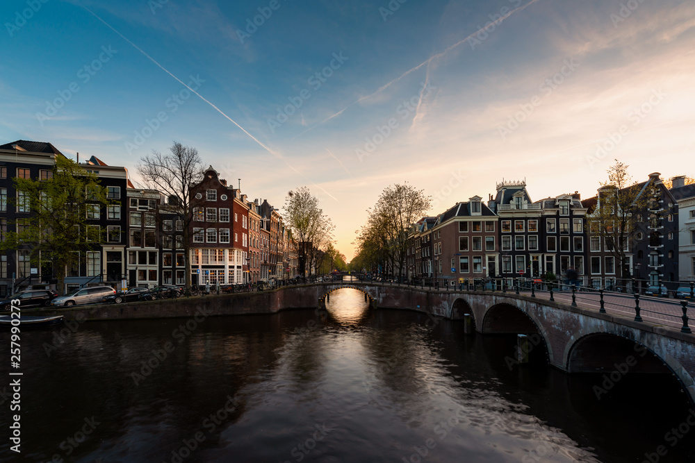 City view of Amsterdam, the Netherlands with Amstel river during sunset.