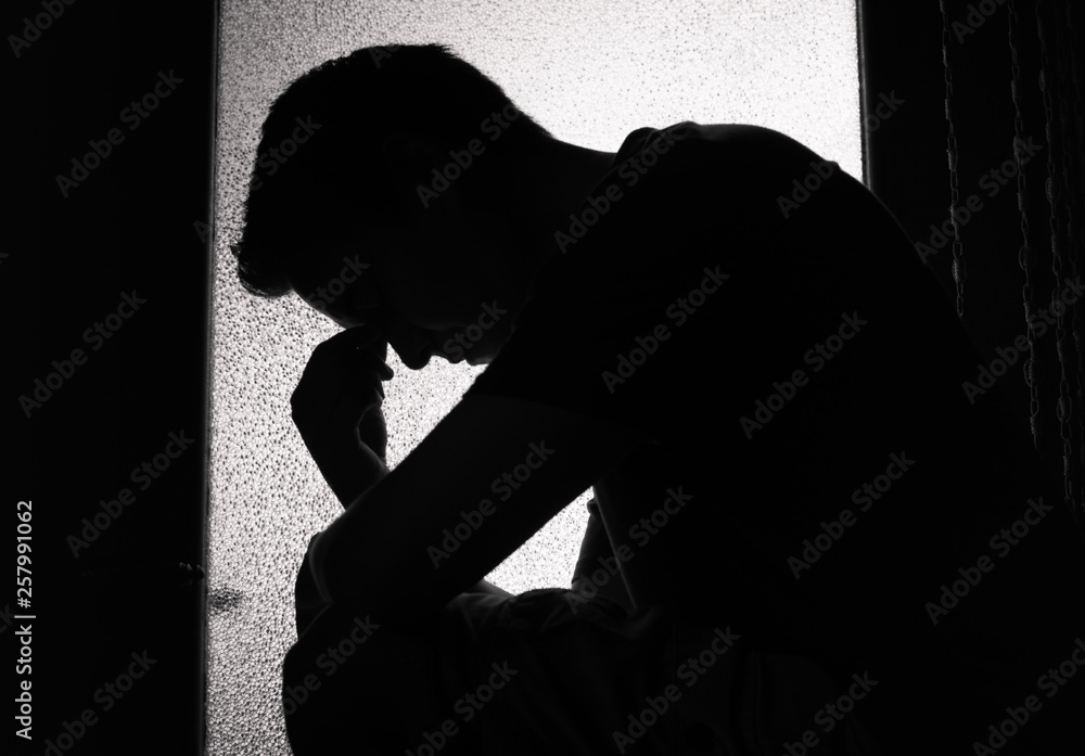 Silhouette Of Young Man Feeling Sad Tired Sitting In A Dark Room Stock silhouette-of-young-man-feeling-sad-tired-sitting-in-a-dark-room-stock