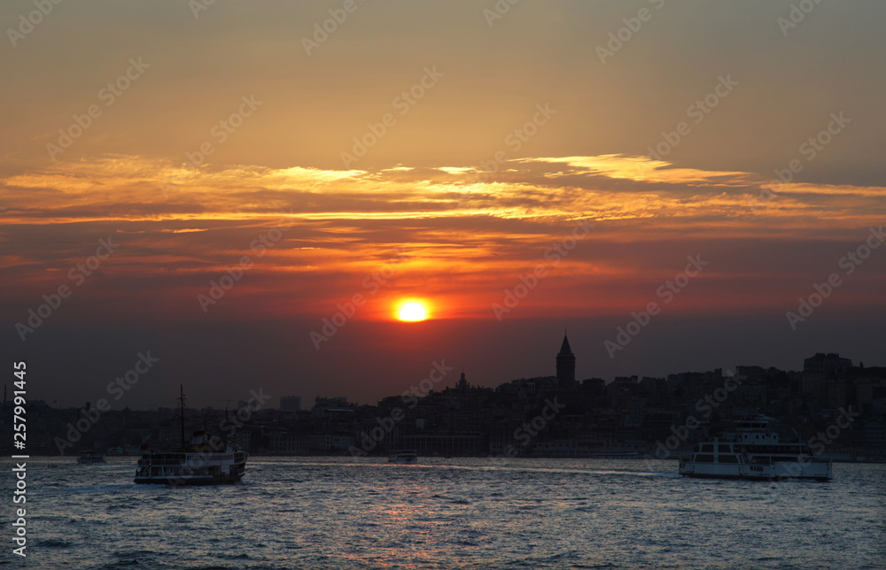 During the sunset historical peninsula and Galata Tower in Istanbul, Turkey. This picture was taken from the Kadikoy District.