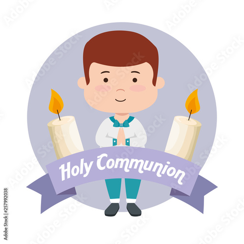 boy with candles and ribbon to first communion
