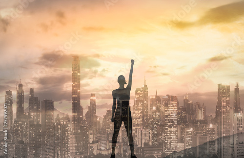 Strong confident woman in the city with her fist up in the air Fototapeta