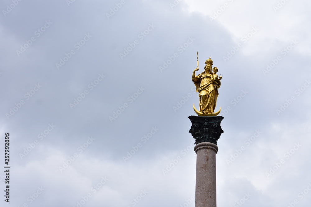 Golden statue on a column at the Marienplatz Golden statue on a column at the Marienplatz