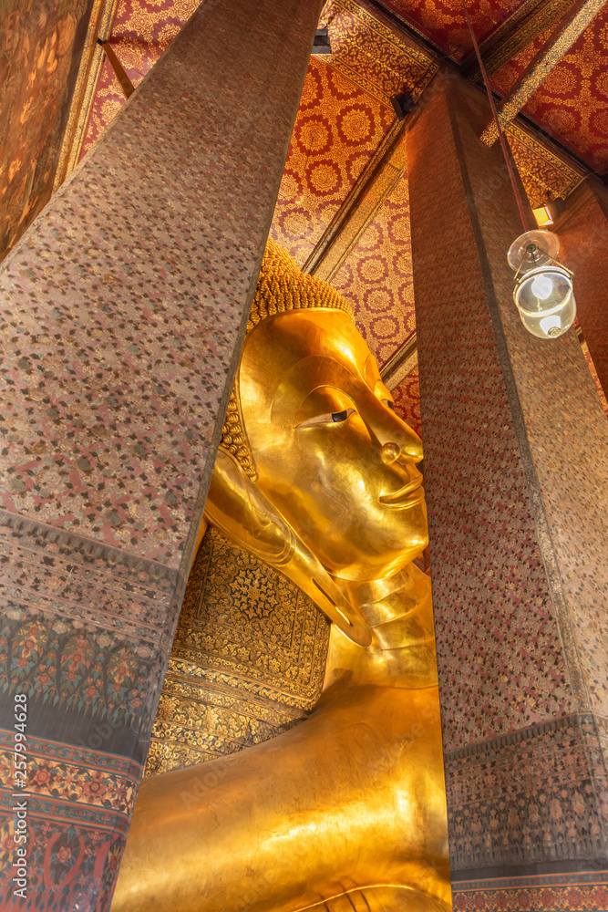 The Reclining Buddha at the Wat Arun Ratchawararam temple complex in the Bangkok.  The Buddha that measures 46 metres long and is covered in gold leaf.