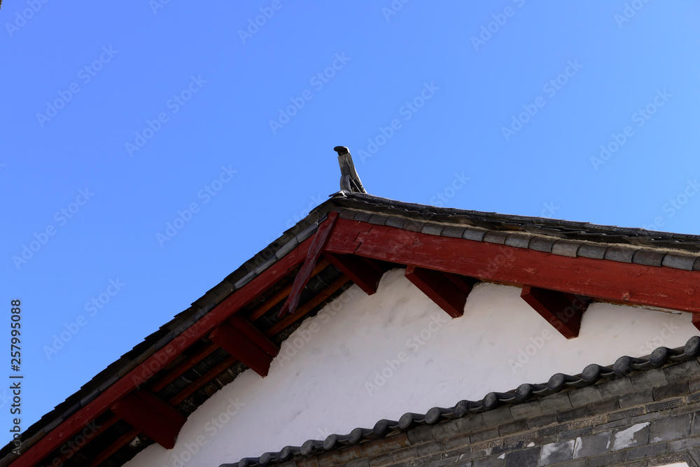 The corner of the ancient building against the blue sky