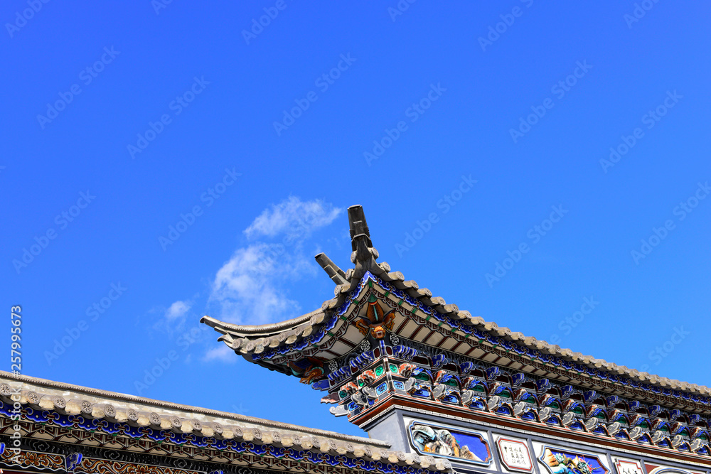 The corner of the ancient building against the blue sky The corner of the ancient building against the blue sky