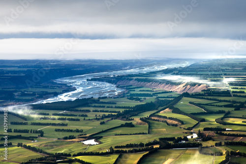 Wide open view over landscape. Patchwork like fields and winding blue river. Canterbury plains landscape. beautiful landscape background. new Zealand outdoors and adventure. photo