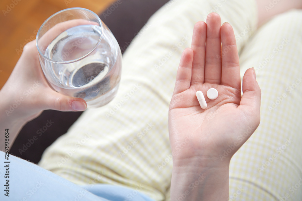 Young woman taking a pill Young woman taking a pill