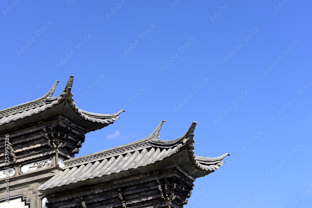 The corner of the ancient building against the blue sky The corner of the ancient building against the blue sky