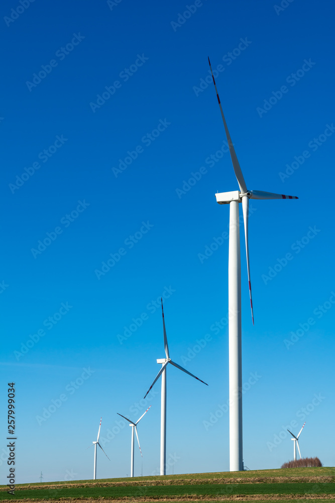 Field with windmills for electric power. Clean energy produced by the wind. Extraction of energy from the air Field with windmills for electric power. Clean energy produced by the wind. Extraction of energy from the air