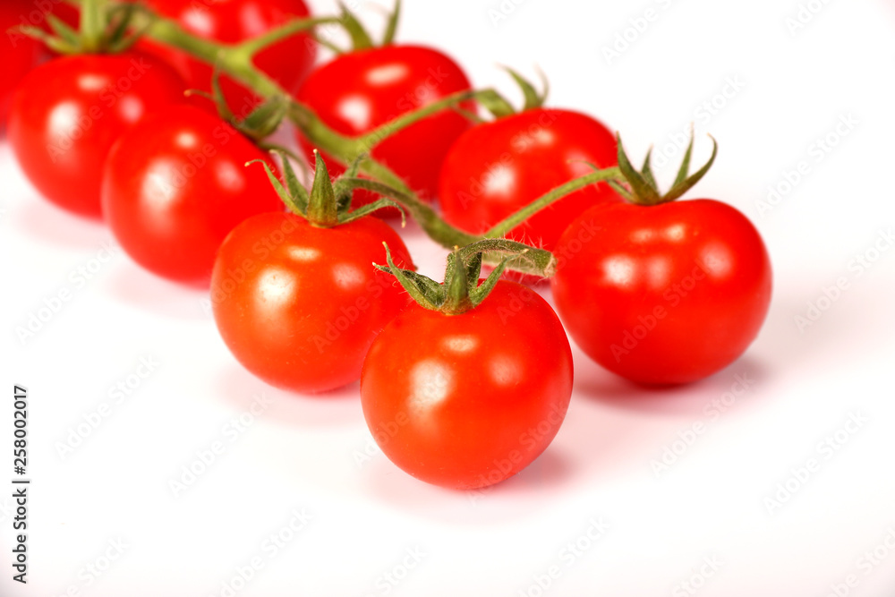 Ripe fresh Juicy organic cherry tomatoes closeup on branch isolated on a white background. Ripe fresh Juicy organic cherry tomatoes closeup on branch isolated on a white background.