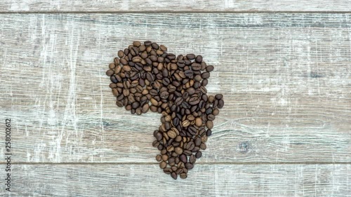 stop motion animation of formation figure of african continent from fresh roasted coffee beans, the figure of africa pulses like a heart, 4K photo