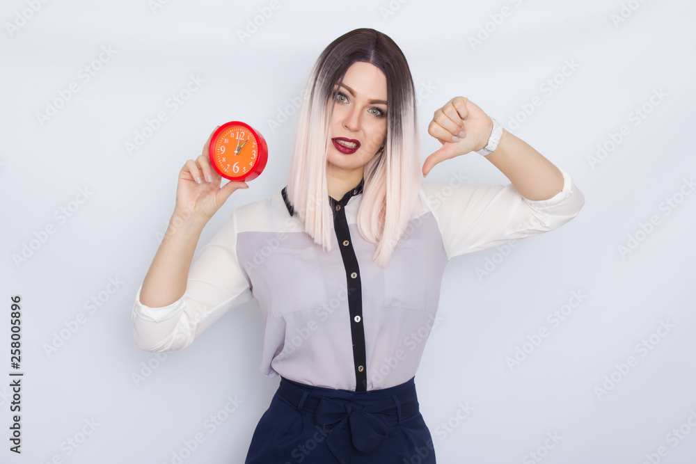 Blonde woman holding red alarm clock in her hands Blonde woman holding red alarm clock in her hands