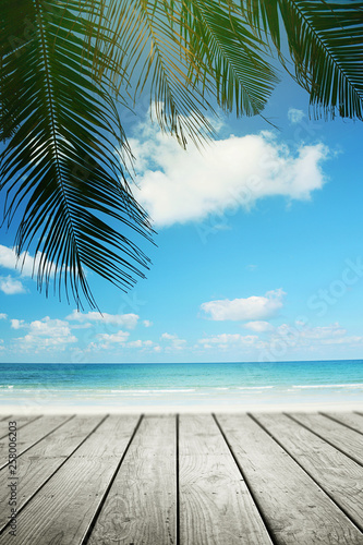 Tropical beach background with palm tree and empty wooden, Summer.