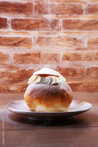 Traditional swedish dessert Semla, also called Shrove bun, with almond paste and whipped cream filling.