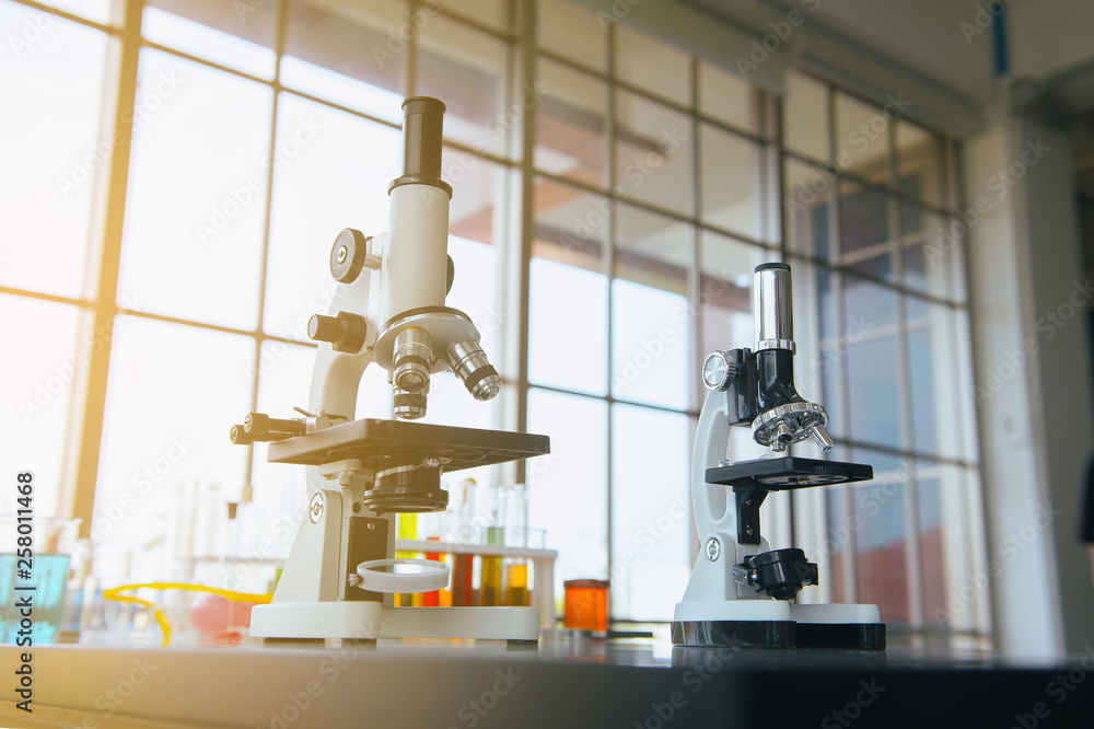 Picture of microscope with metal len for research and medical equipment in lab room Picture of microscope with metal len for research and medical equipment in lab room