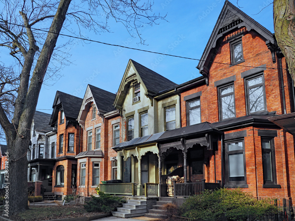 Row of old Victorian style brick houses with gables