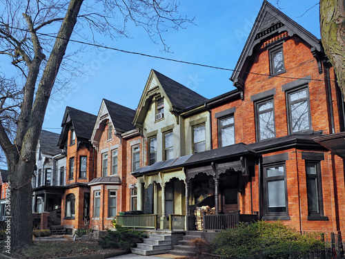 Row of old Victorian style brick houses with gables © Spiroview Inc.