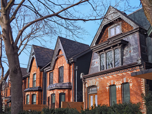 Row of old Victorian style brick houses with gables