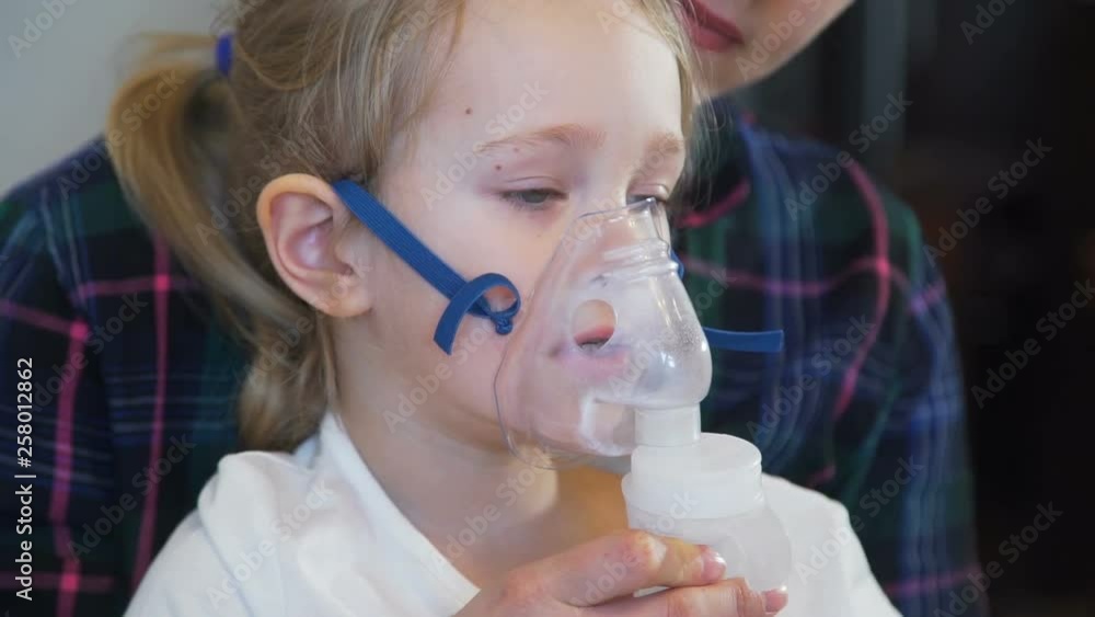 Little Girl Inhales with Face Mask of Nebulizer Little Girl Inhales with Face Mask of Nebulizer
