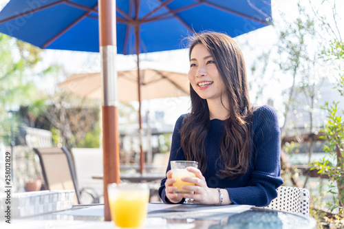 オープンテラスカフェで余暇を楽しみむ女性 #258012829