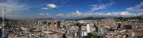 Panorama of quito showing both high and low buildings with a bright blue sky