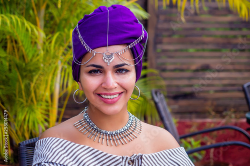 Fashion afro american girl with ethnic turban on head culture coffeebreak at summer tropical cafe