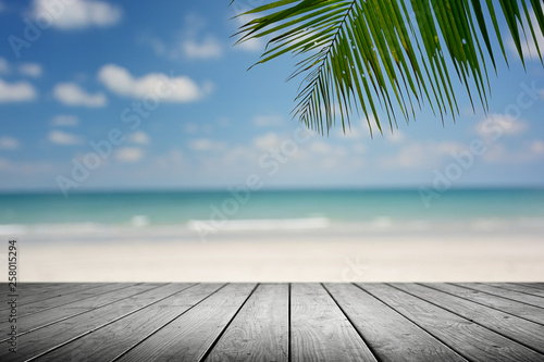 Beach background with palm tree and empty wooden  Summer.