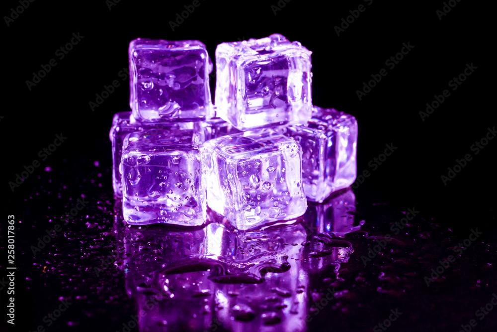 Purple ice cubes on a black table. Purple ice cubes on a black table.