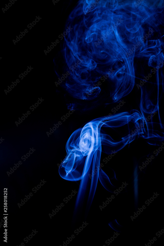 Fototapeta premium Blue toxic fumes movement on a black background.