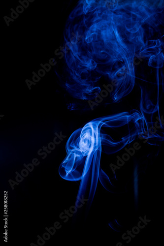 Blue toxic fumes movement on a black background.