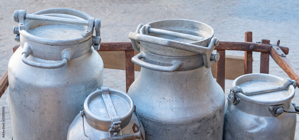 4 traditional milk metallic tanks with different size 4 traditional milk metallic tanks with different size