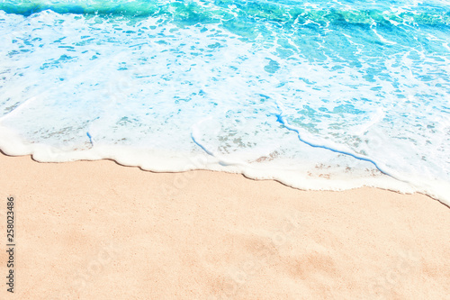 Blue ocean wave on sandy beach. Summer day and sand beach background